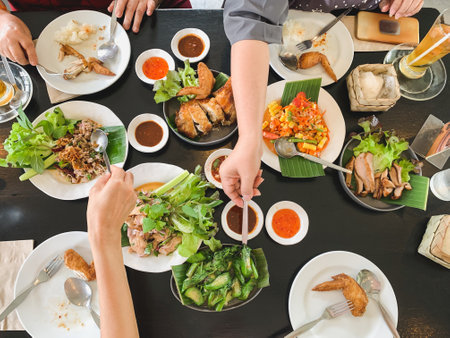 Top view of family eating food together at lunch time.の写真素材