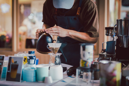 Barista pouring hot water to make drip coffee.の写真素材