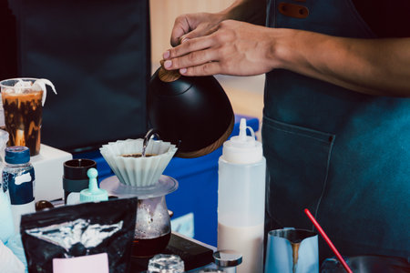 Barista pouring hot water to make drip coffee.の写真素材