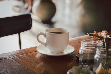 A cup of black coffee on breakfast table in the morning.