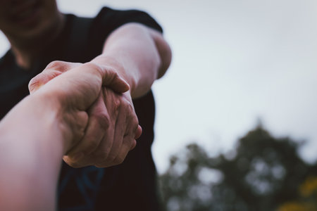 Help concept hands reaching out to help each other.の写真素材