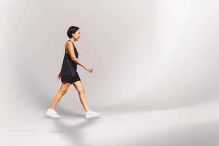 Woman exercise walking on the street hand holding bottle waterの写真素材