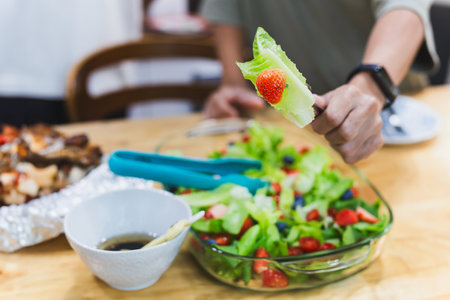 Man eating healthy vegetable and fruit saladの写真素材