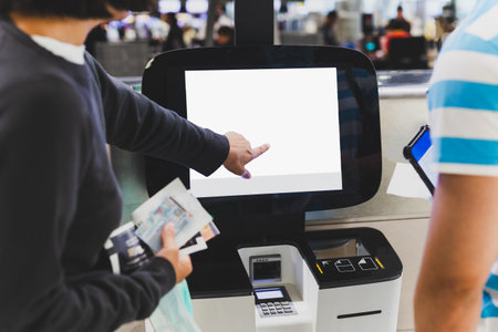 Passenger couple doing self check in kiosks at International Airportの写真素材