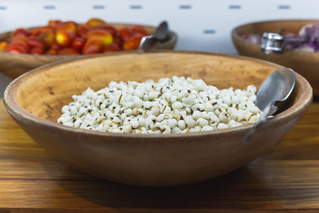 Healthy soft focus of boiled Millet in wooden bowl for breakfastの写真素材