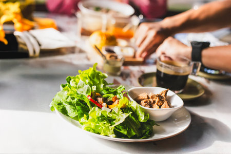 Close up of healthy vegetable salad with coffee on table