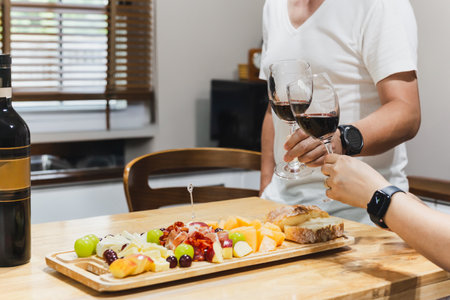 Couple hand clicking glasses of wine celebrationの写真素材