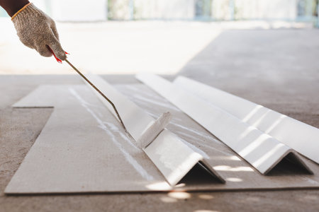 Hand painting a metal box for new roof with roller painterの写真素材