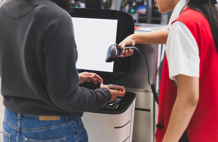Woman self check in with hand scanning barcode in the airportの写真素材