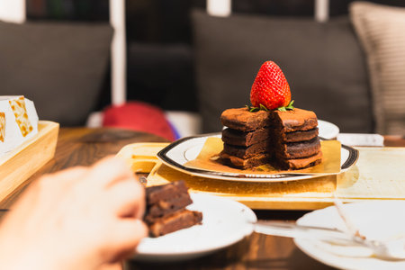 Chocolate cake with piece take out on table in restaurantの写真素材