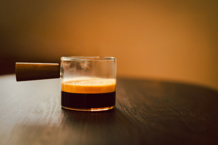 Espresso coffee in a glass cup on wooden tableの写真素材