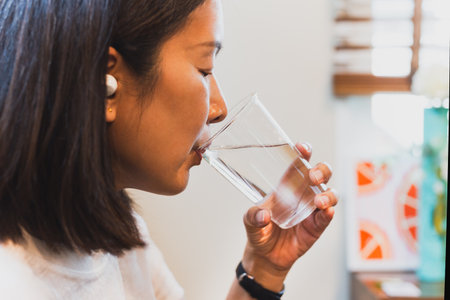 Woman drinking fresh cold water from glassの写真素材