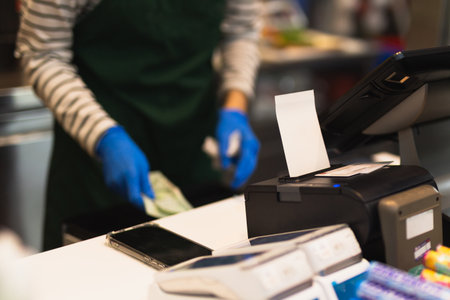Selected focus Credit card payment and bill for purchase with cashier in blur background.
