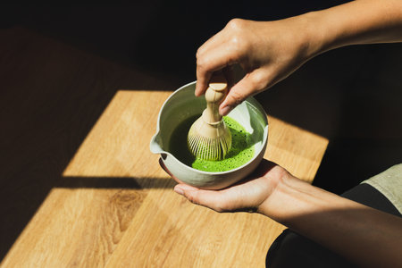 Barista preparing matcha green tea in cafe.の写真素材