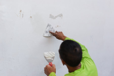Painters hand puttied wall using a paint trowel.の写真素材