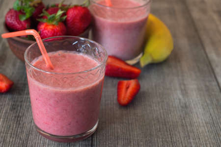 Strawberry milkshake with berries and banana in the glass jar.の写真素材