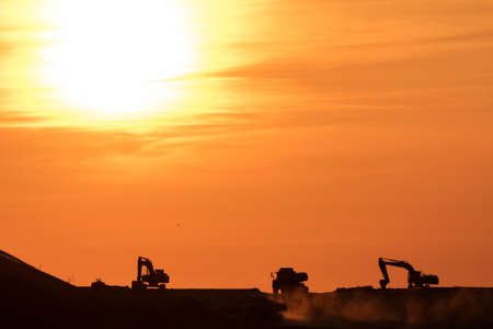 Building a road with varied machinery at sunset. Copy Space.の写真素材