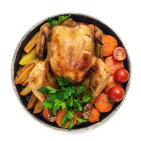 Roasted chicken, potatoes and vegetables in plate isolated on white background. Top view.の写真素材
