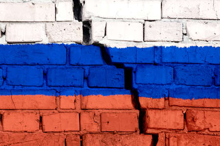 Flag of Russia on the brick wall with big crack in the middle. Destruction and separatism concept.の写真素材