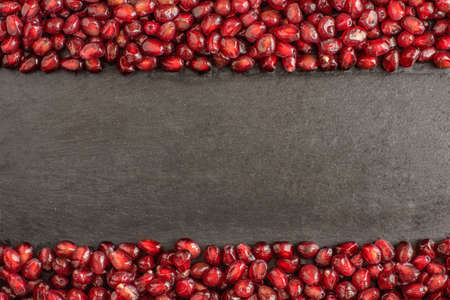 pomegranate seeds over dark background with copy space.の写真素材