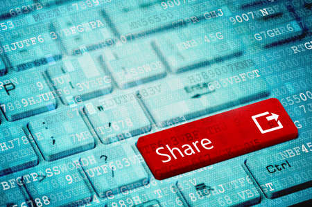 Red key with text Share on blue digital laptop keyboard.の写真素材