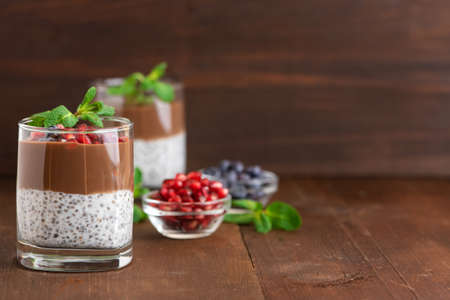 Chocolate chia pudding in glass on dark wooden background. With copy space.の写真素材