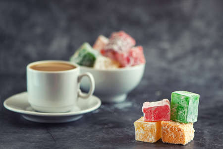 Traditional turkish delight and cup of coffee on gray background.の写真素材