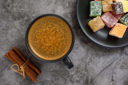 Turkish delight and cup of coffee on gray background. Top view.の写真素材