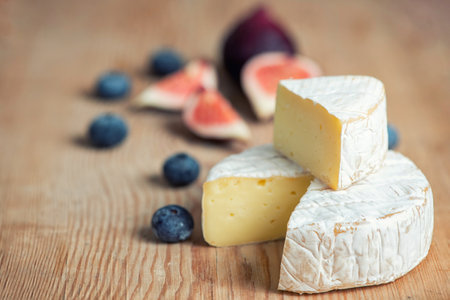 camembert cheese with figs and blueberries on dark background.の写真素材