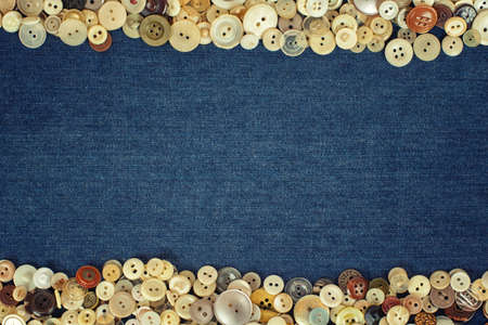Vintage Buttons frame on a denim fabric texture background.の写真素材