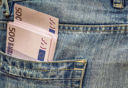euro bank notes in jeans pocket.