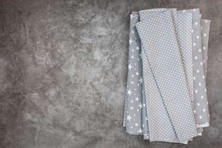 Natural gray fabrics and textiles on gray background. Sewing industry concept. With copy space.の写真素材