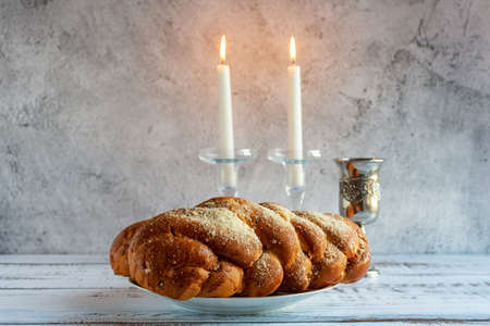Shabbat Shalom - challah bread, shabbat wine and candles on wooden table.の写真素材