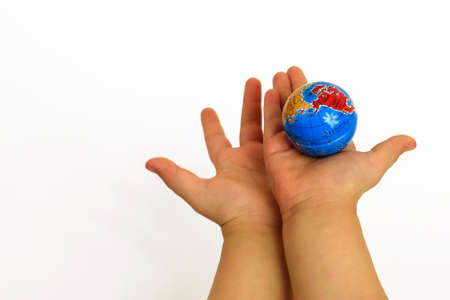 Child's hands hold the globe.の写真素材
