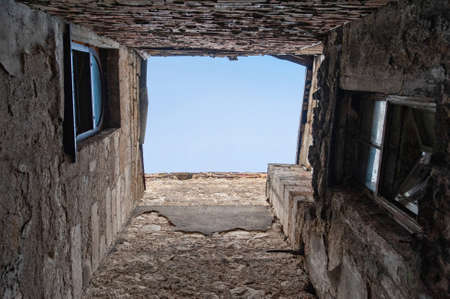 Looking up at old building to sky in perspective view.の写真素材