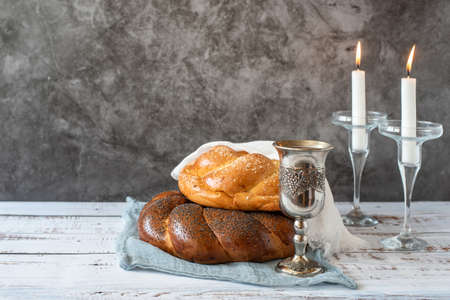 Shabbat Shalom - challah bread, shabbat wine and candles on gray background. With copy space.の写真素材