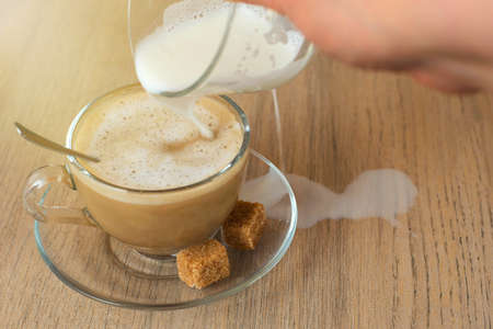 milk spilled on the desk while added to coffee.の写真素材