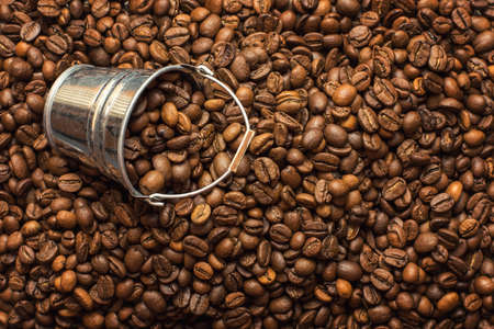 Coffee beans texture with a small decorative bucket.の写真素材