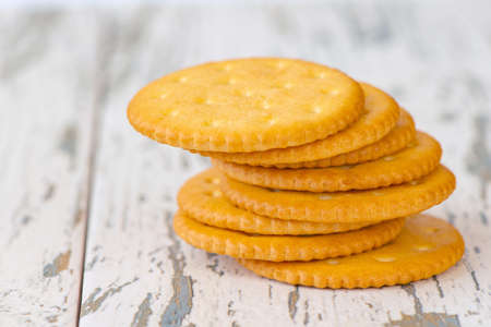 A few dry cracker cookies on a old wooden board.