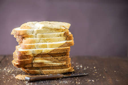 Sliced of marble bread on rustic wooden table. With copy space.
