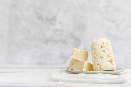 Sliced feta cheese on light background. High key. With copy space.の写真素材