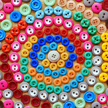 Spiral from colorful buttons for background. Top view.