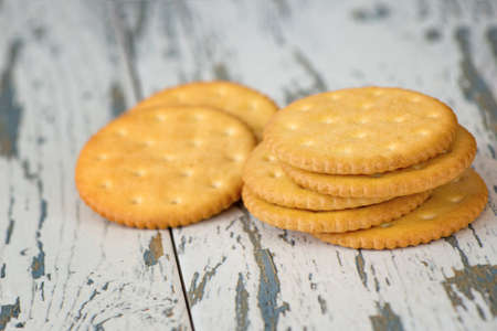 A few dry cracker cookies on a old wooden board.