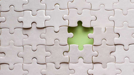 White details of puzzle on green background.の写真素材