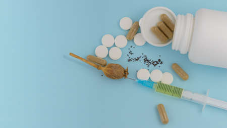 Drug addiction on a blue background. Syringe pills mac.の写真素材