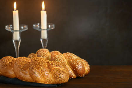 Shabbat Shalom - challah bread, shabbat candles on wooden table.の写真素材