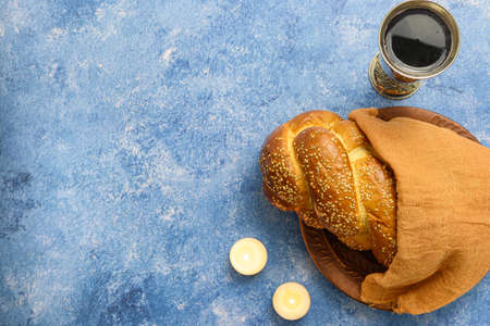 Shabbat Shalom - challah bread, shabbat wine and candles on table. Top view.の写真素材