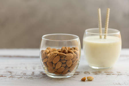 Almond milk in glass with almonds. Cocktail with almond milk.の写真素材