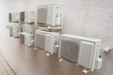 Air conditioner machines on old wall. Air condition system outdoor unit.の写真素材