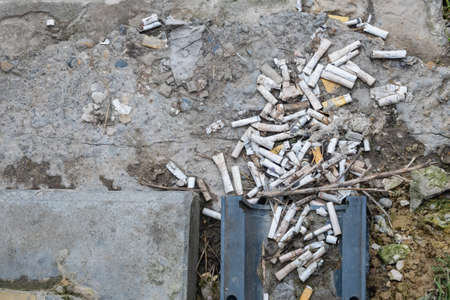 Filter from old used cigarettes on the ground.の写真素材